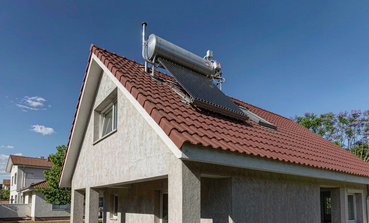 Solar geyser (solar water heater) with evacuated tube collector installed on the tile roof of a South African home
