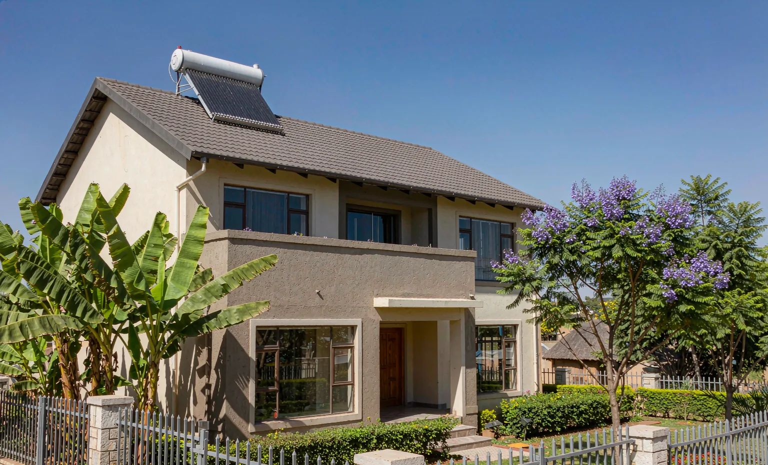 Solar water heater with evacuated tube collector installed on the roof of a family home in Nairobi, Kenya